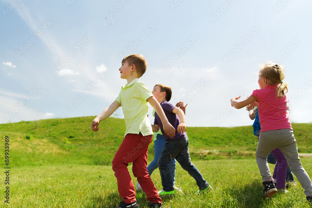 group of happy kids running outdoors group of happy kids running outdoors