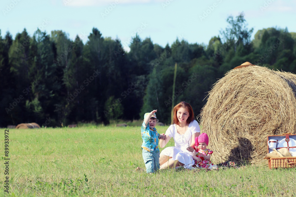 Fototapeta premium mother with twins in field