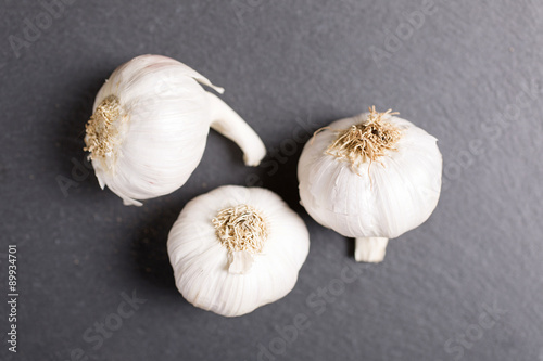 Fresh raw garlic on black slate