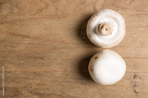 Selection of fresh raw mushrooms on a wooden kitchen work surface
