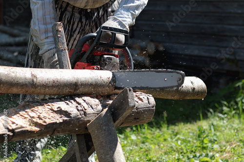 Fototapeta Naklejka Na Ścianę i Meble -  chainsaw to cut firewood