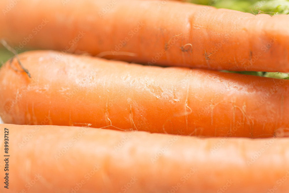 Selections of raw fresh organic carrots on a light wooden work surface Selections of raw fresh organic carrots on a light wooden work surface