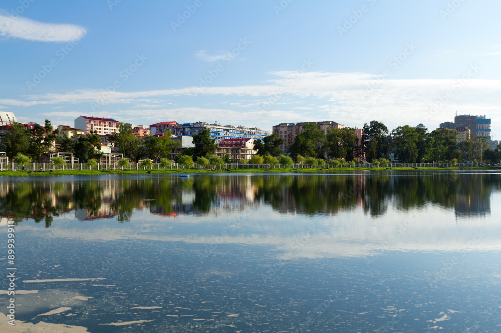 Houses reflected in the water of Lake Nuri. Batumi. Georgia