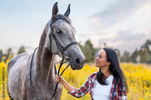 Young woman with a horse