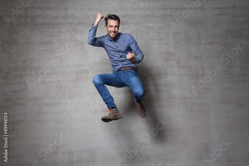 euphoric business man jump wall photo