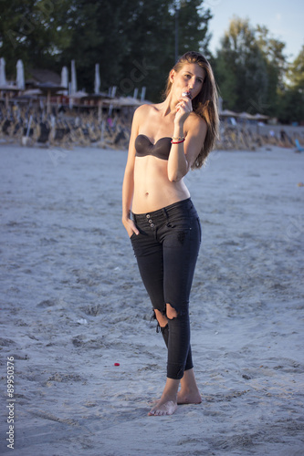 Girl eating ice cream on beach, on beautiful sunny day. photo