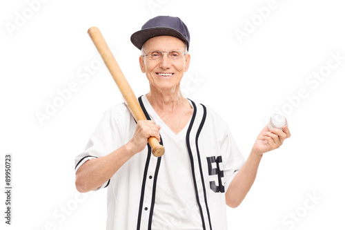 Canvas Print Active senior in baseball jersey holding a baseball bat and a ba