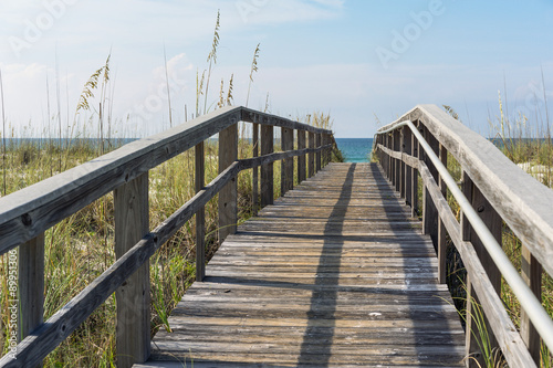 Rustic Wood Beach Boardwalk through Sand Dunes photo