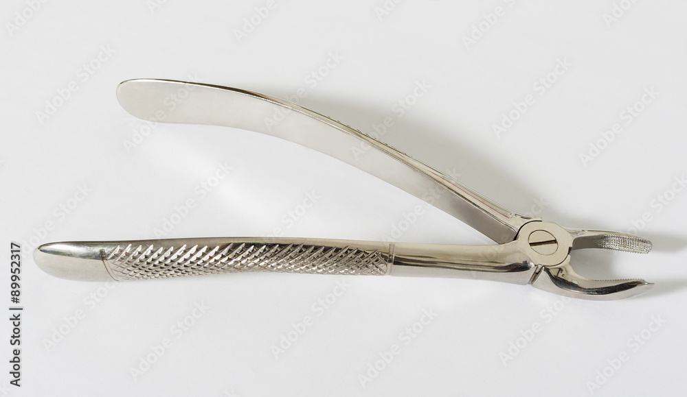 Chromed dental pliers on a blank white background. Chromed dental pliers on a blank white background.