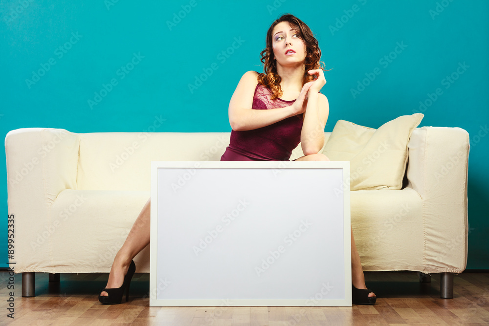 woman on sofa holding blank presentation board. woman on sofa holding blank presentation board.