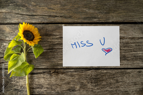 Romantic Miss u message next to a beautiful sunflower