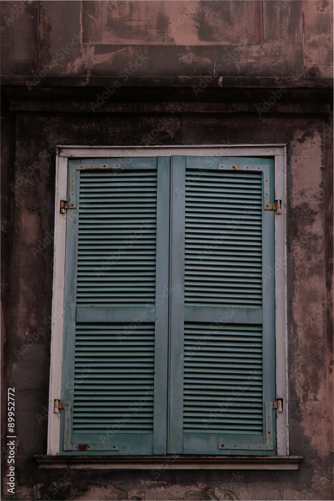 Shuttered window on concrete building