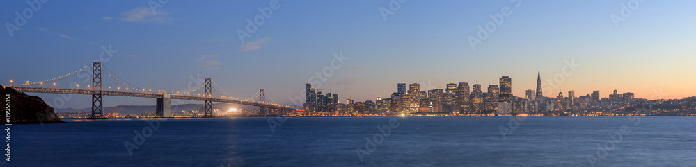 San Francisco – Oakland Bay Bridge with lights at sunset time