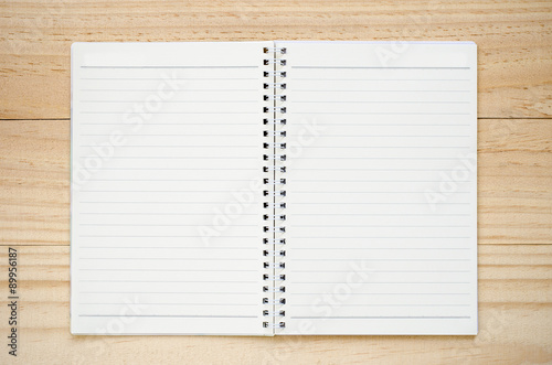 Notebook on wood background.