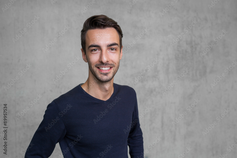 portrait of a young man smiling with space