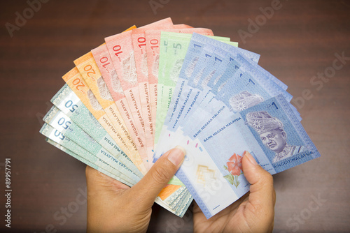 hand holding with Malaysian money banknotes