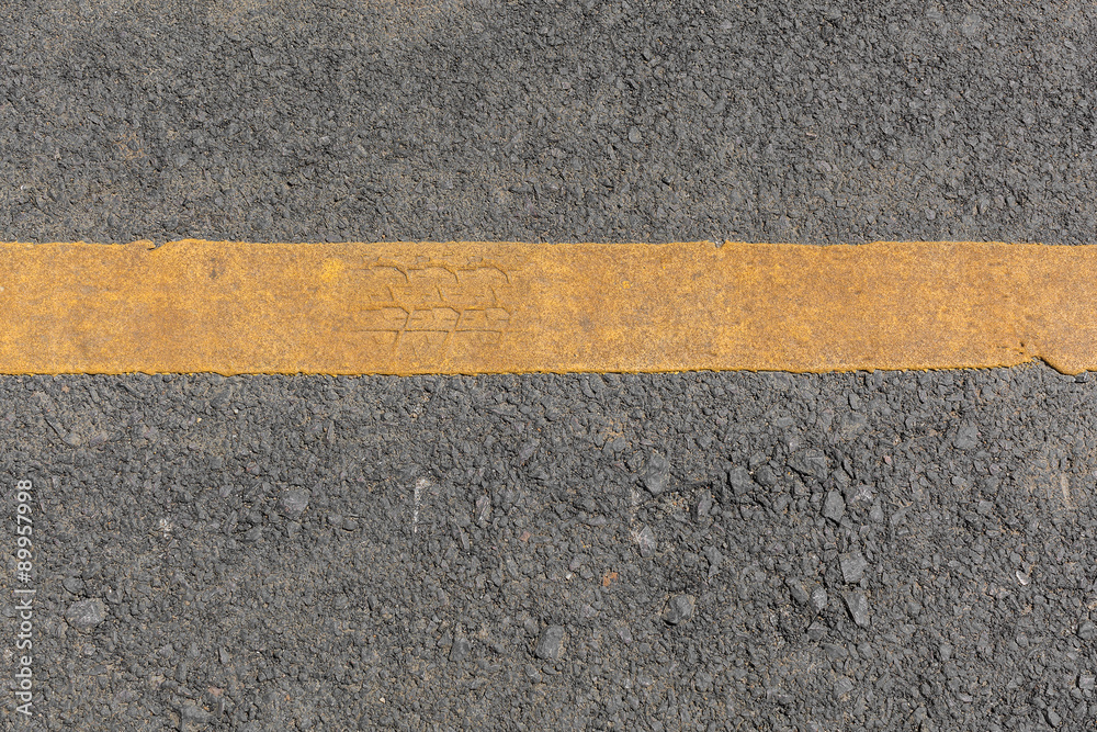 Fototapeta premium Yellow line dirty on black asphalt road texture
