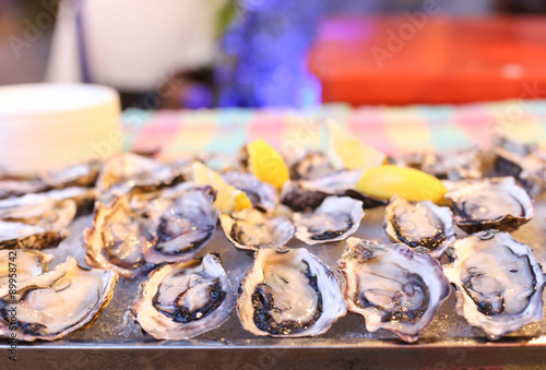 Freash oysters on ice tray and lemon