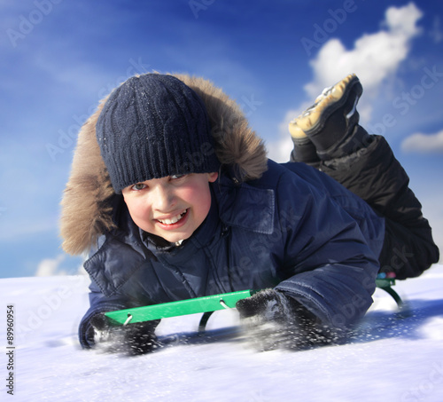 Konstfotografi happy boy on sled
