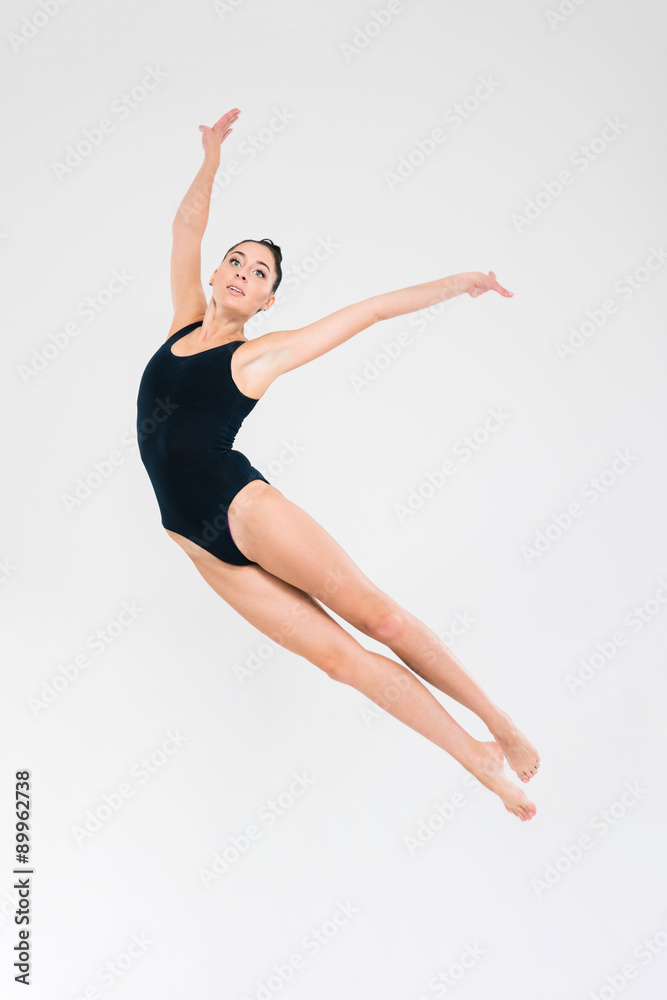 Fototapeta premium Woman in gymnast suit doing acrobatic stunt