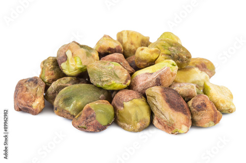 Close-up of a heap of pistachio seeds with no shell, isolated on white background.