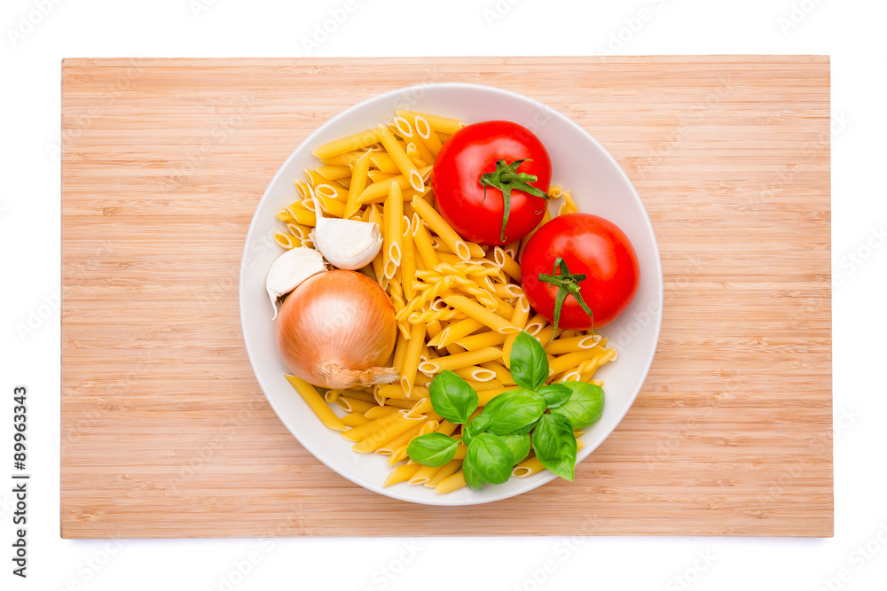 Wooden cutting board with a plate of ingredients on it Wooden cutting board with a plate of ingredients on it