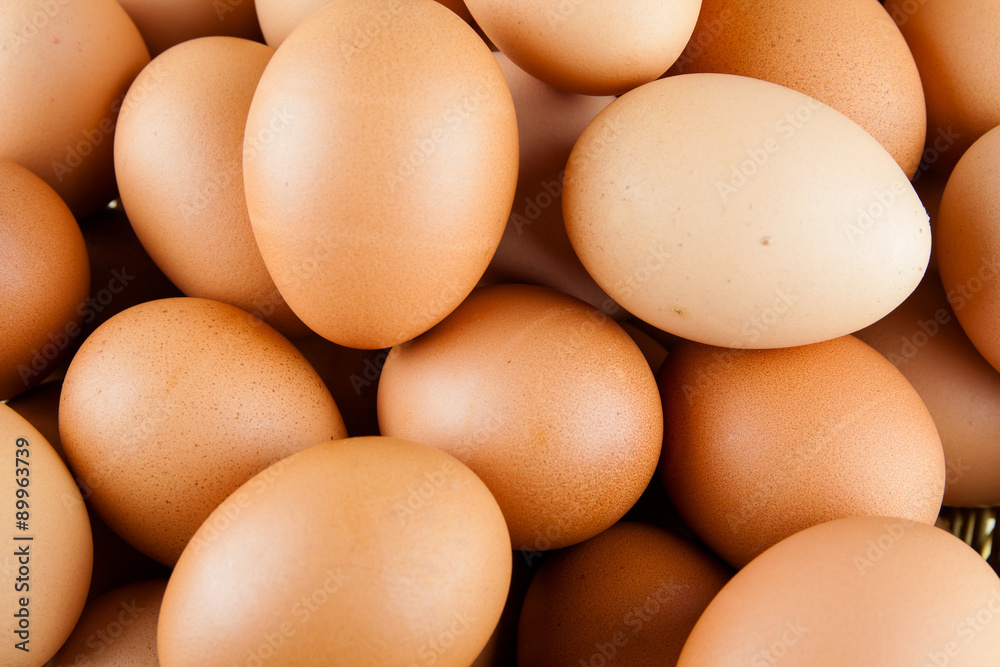 Full of Eggs put in a wicker basket in wooden background Full of Eggs put in a wicker basket in wooden background