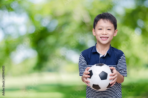Young Asian boy with ball in park © gamelover