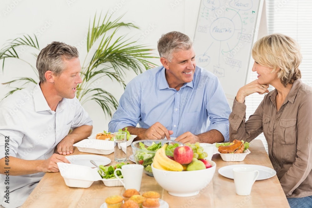Smiling business colleagues having lunch together