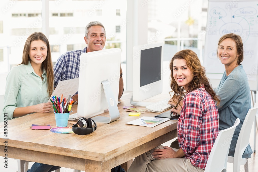 Fototapeta premium Four casual colleagues using computer