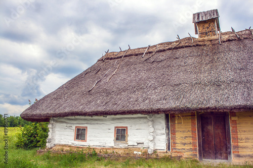 Ukrainian hut thatched sloping field near #89968571