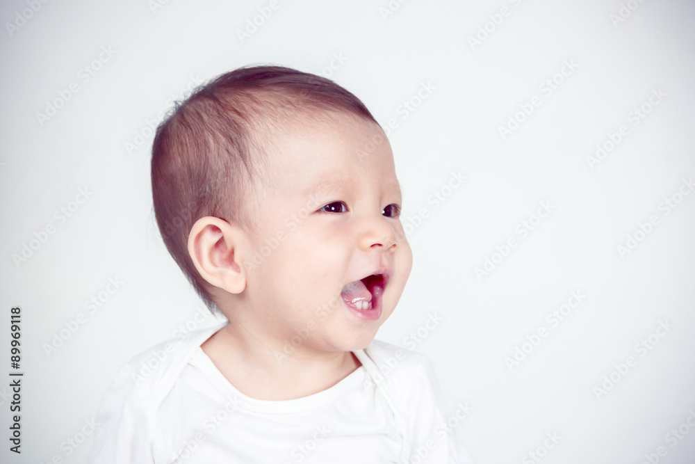 Asian baby girl smiling, studio shot (soft focus on the eyes) Asian baby girl smiling, studio shot (soft focus on the eyes)