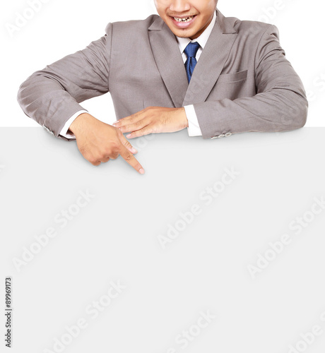  Young businessman pointing at a blank board, isolated on white background