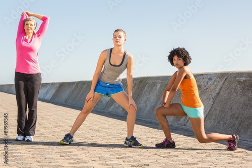 Sporty women stretching together