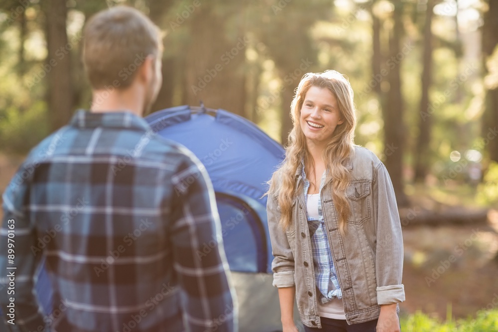 Happy young camper couple looking at each other Happy young camper couple looking at each other