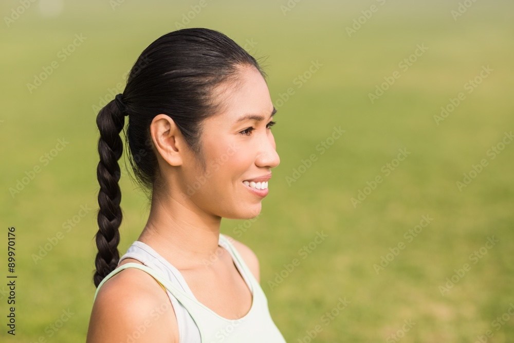 Smiling sporty woman looking away