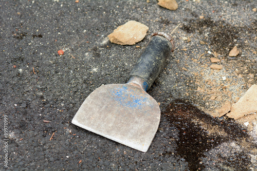 Bricklayers bolster chisel on ground besides wall