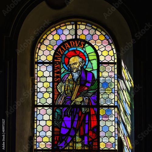 Sun light through the leaded pane in old majestic church