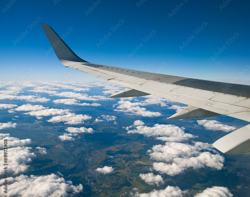 Wing of the plane on blue sky Wing of the plane on blue sky