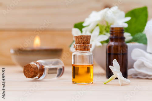 Aroma oil bottles arranged with jasmine flowers 