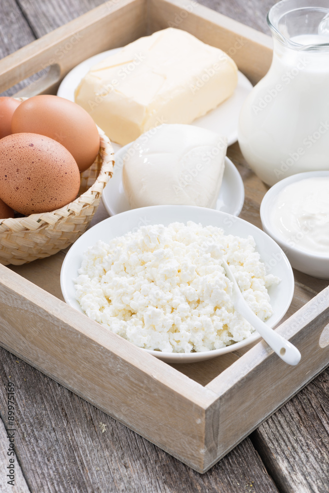 fresh dairy products on wooden tray, vertical fresh dairy products on wooden tray, vertical