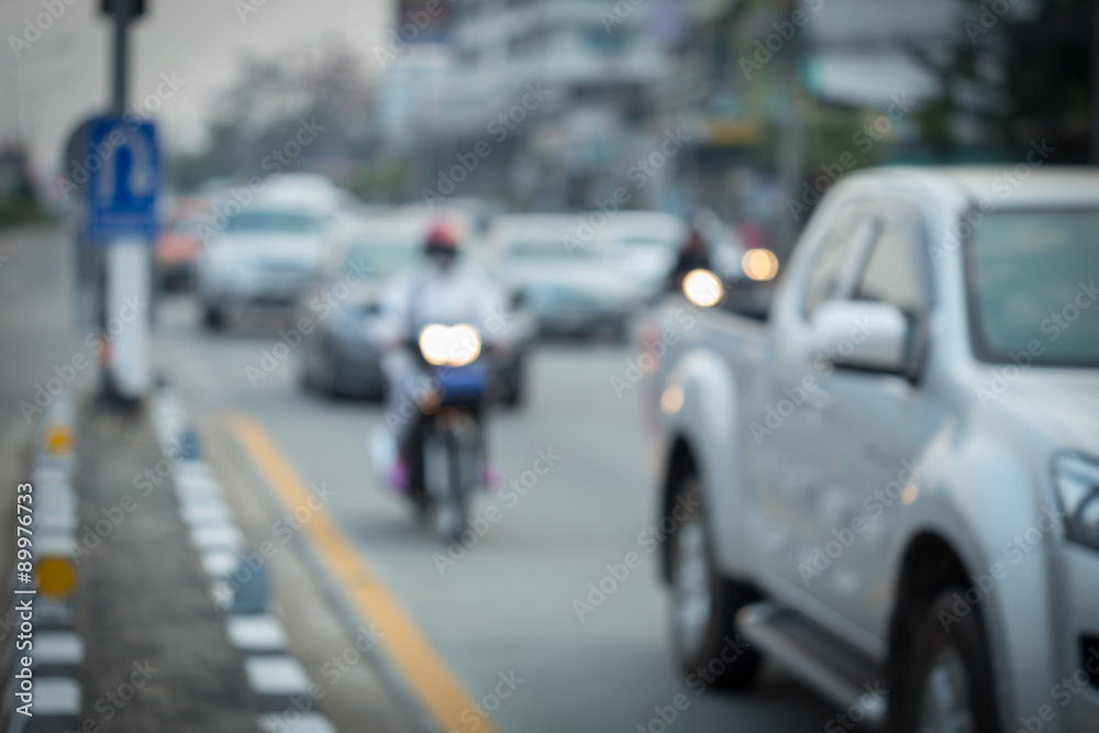 car and motorcycle driving on road with traffic jam in the city, abstract blurred