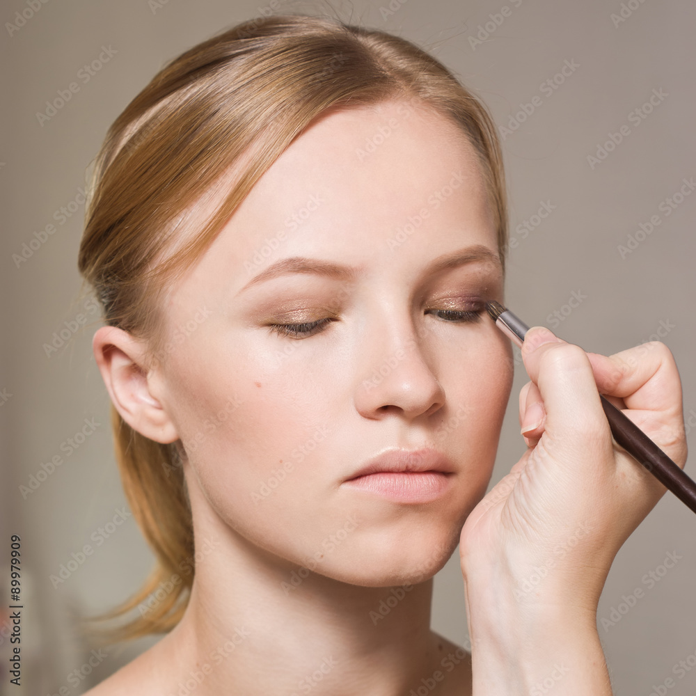Make-up artist applying liquid eyeliner with brush