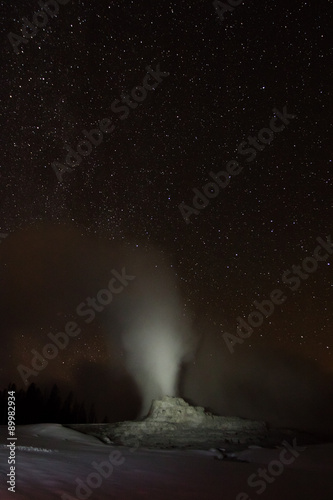 castle geyser erupting on a starry night