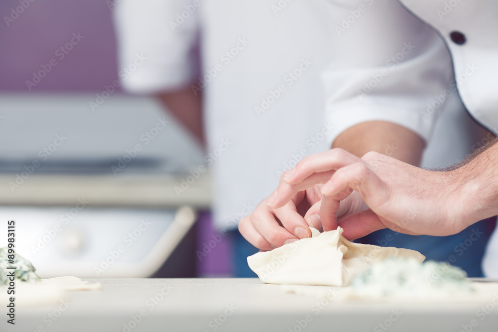 Vegetarian bakery concept. Cook's hands putting filler Vegetarian bakery concept. Cook's hands putting filler