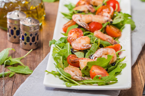 Salad with shrimps or prawn, tomato and arugula