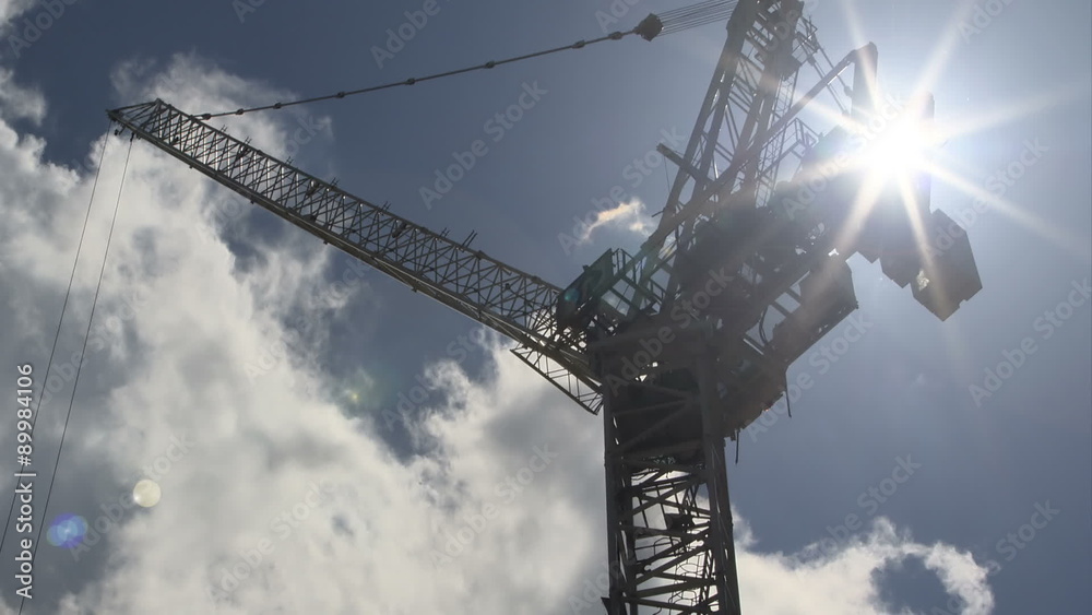 Multilevel crane on a background of clouds. Time-Lapse