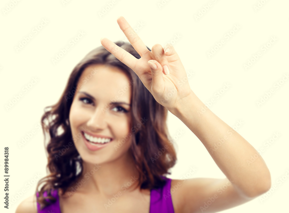 Fototapeta premium Woman showing two fingers or victory gesture