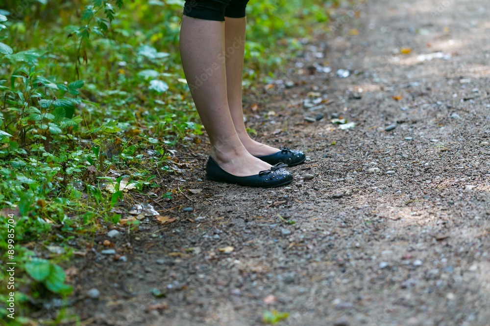 Close up of girl legs walking in forest