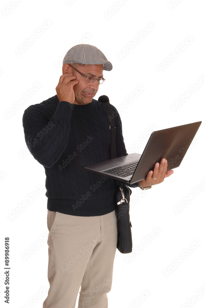 A Hispanic man working on his laptop. A Hispanic man working on his laptop.